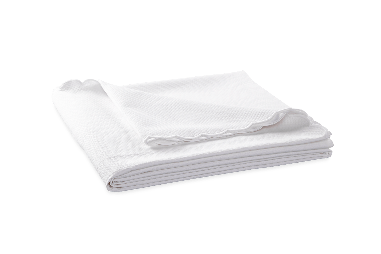 folded diamond patterned white coverlet with scalloped edges