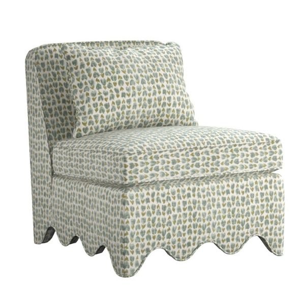 A pop of color accent chair in green with a scalloped base