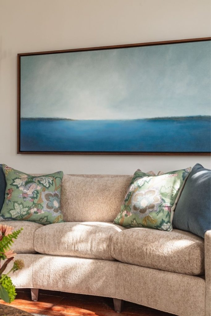 Luxurious custom sofa by Charleston furniture store GDC Home, styled with throw pillows and coastal art and home decor