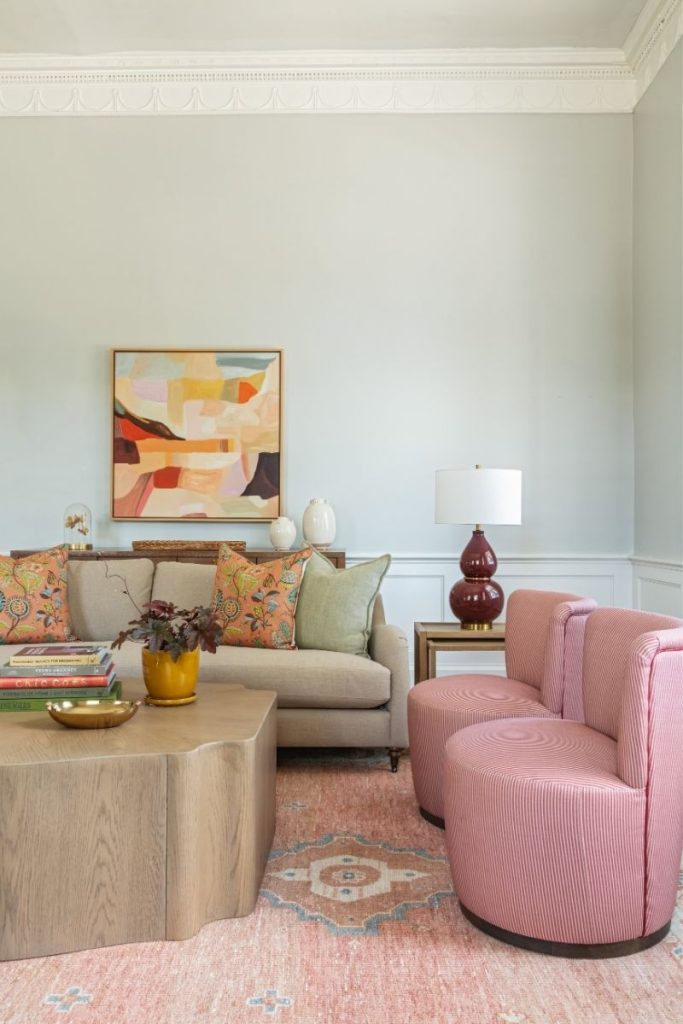 Two accent chairs styled in a Charleston living room, with a bolder interior design style adding character to the room