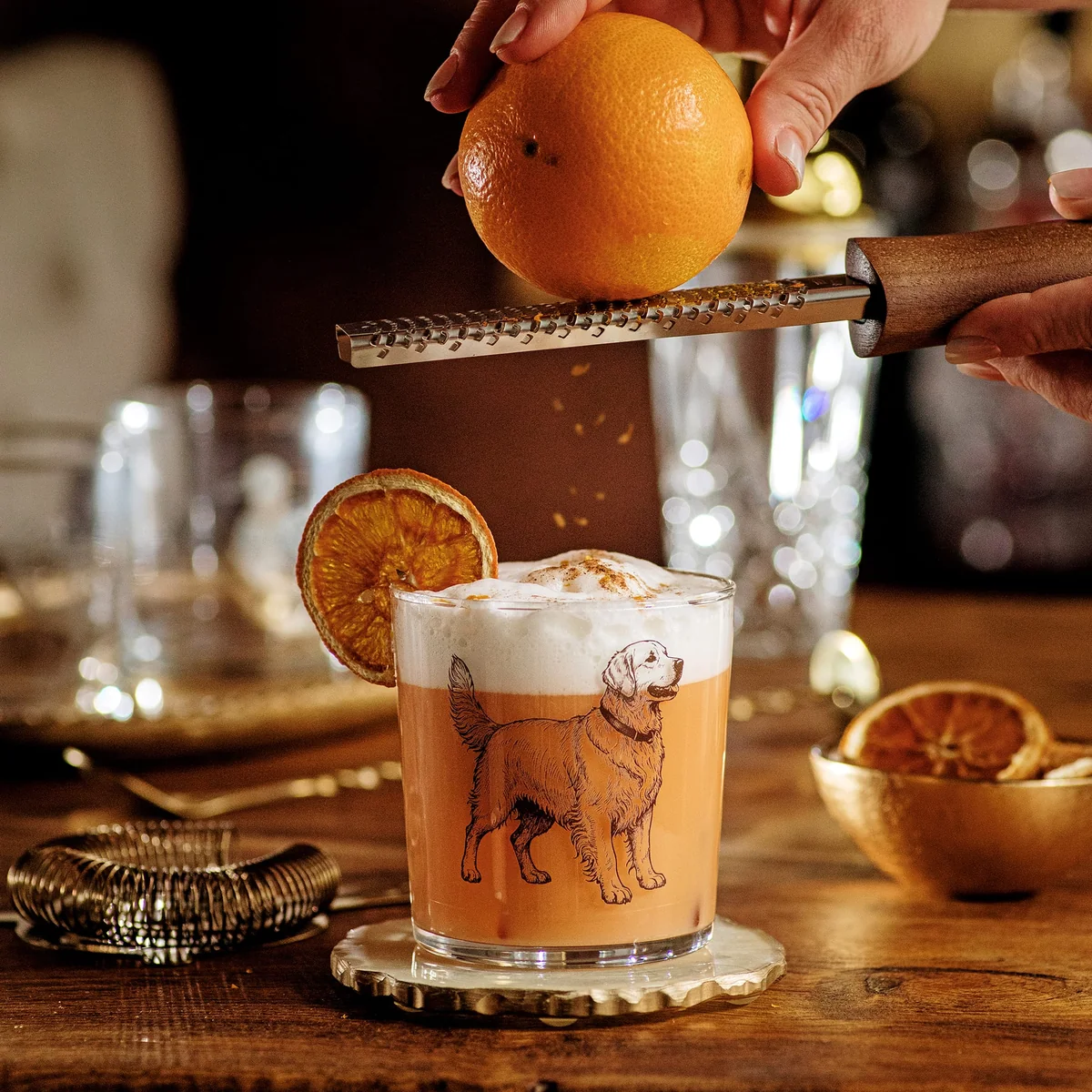 glass tumbler with golden retriever print shown with cocktail and orange zest