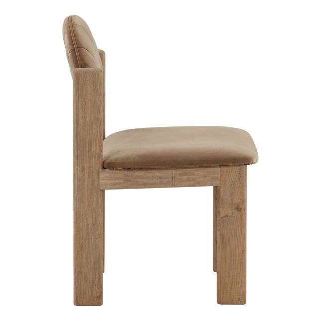 side view of a dining chair with a wood frame, light brown velvet seat and back, and curved scalloped backrest