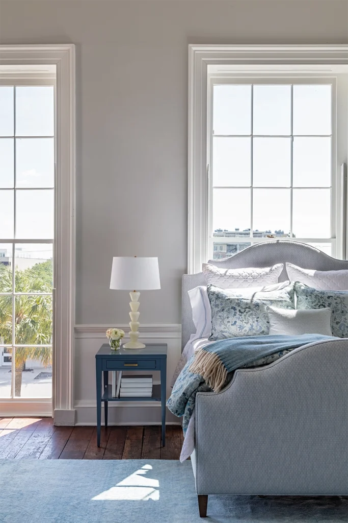 A curved, upholstered bed frame styled by GDC Home bedding stores in Charleston, SC