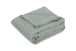 folded coverlet with woven small check pattern in olive green