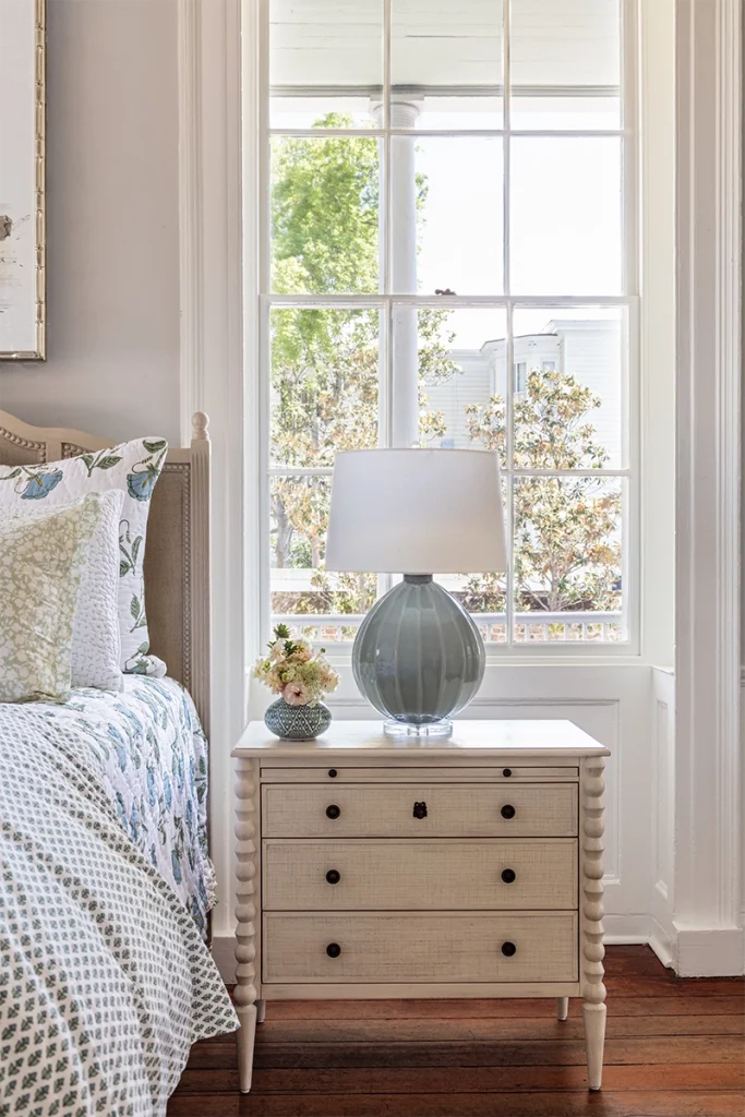 Sculptural lamp on a bedside table sourced from our Charleston lighting stores