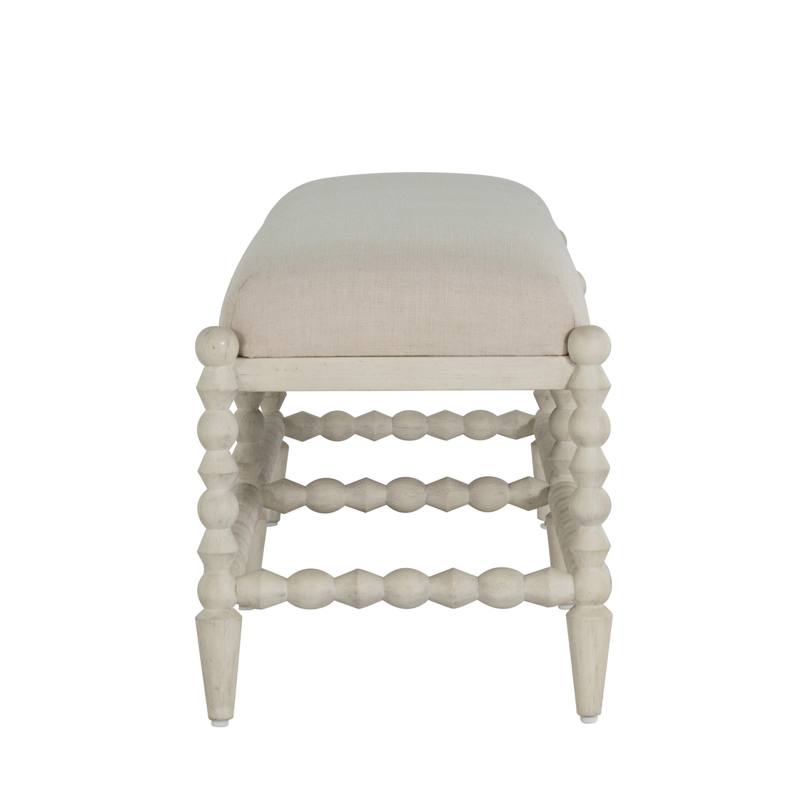 side view of a rectangular bench with bobbin style frame and neutral upholstered top