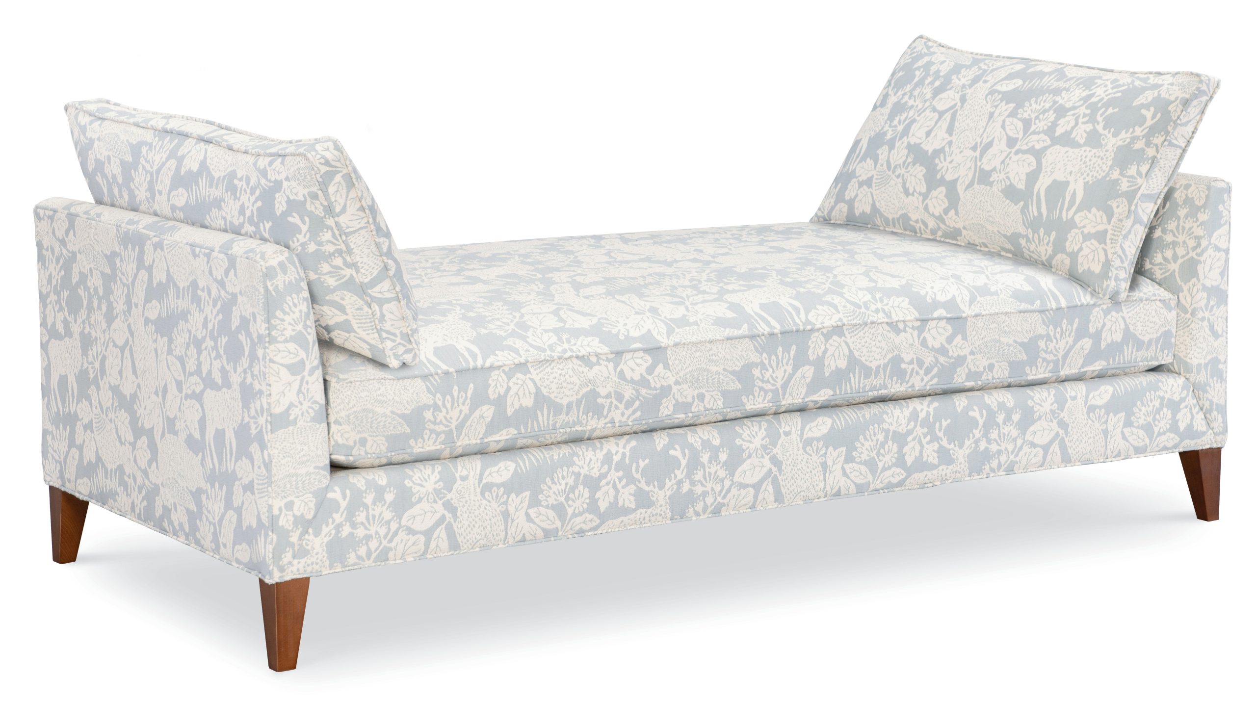daybed upholstered in a light blue and cream woodland animal fabric with brown legs