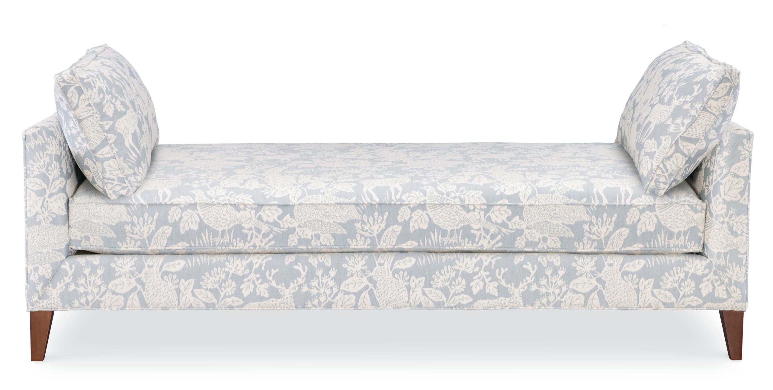 daybed upholstered in a light blue and cream woodland animal fabric with brown legs