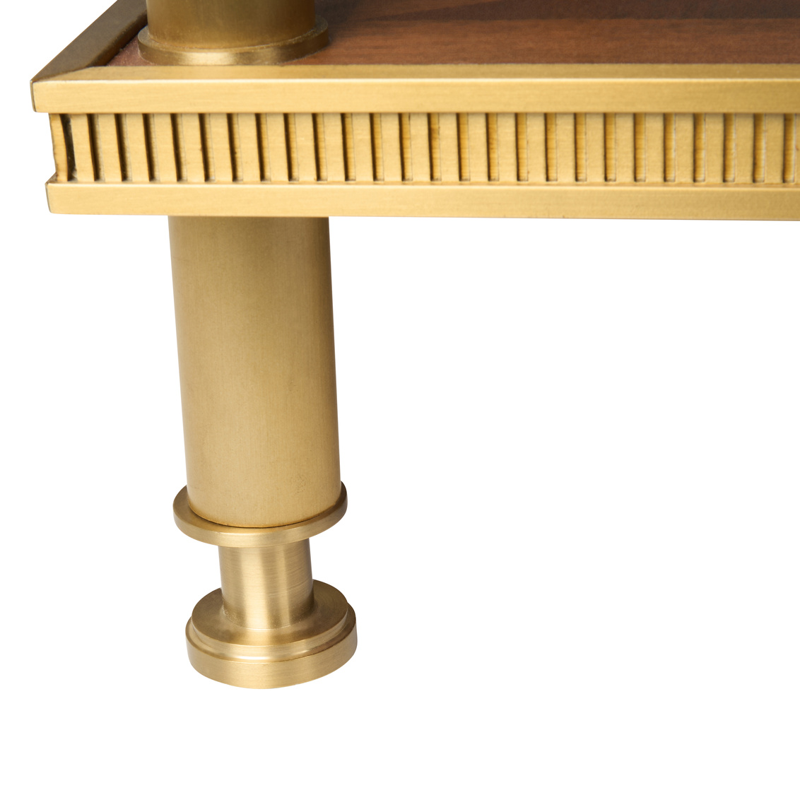detail of brass accents on a brown wood coffee table