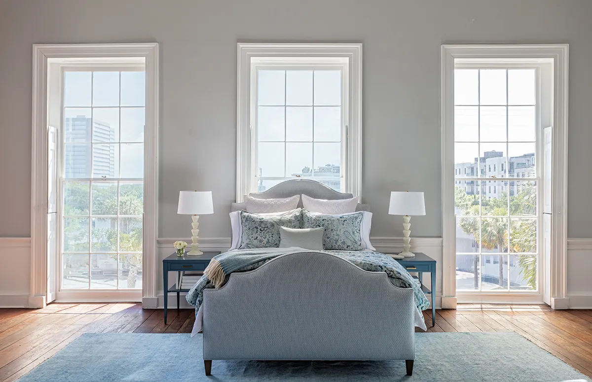 A styled bed with layered bedding arranged by GDC Home, furniture and bedding store in Charleston, SC