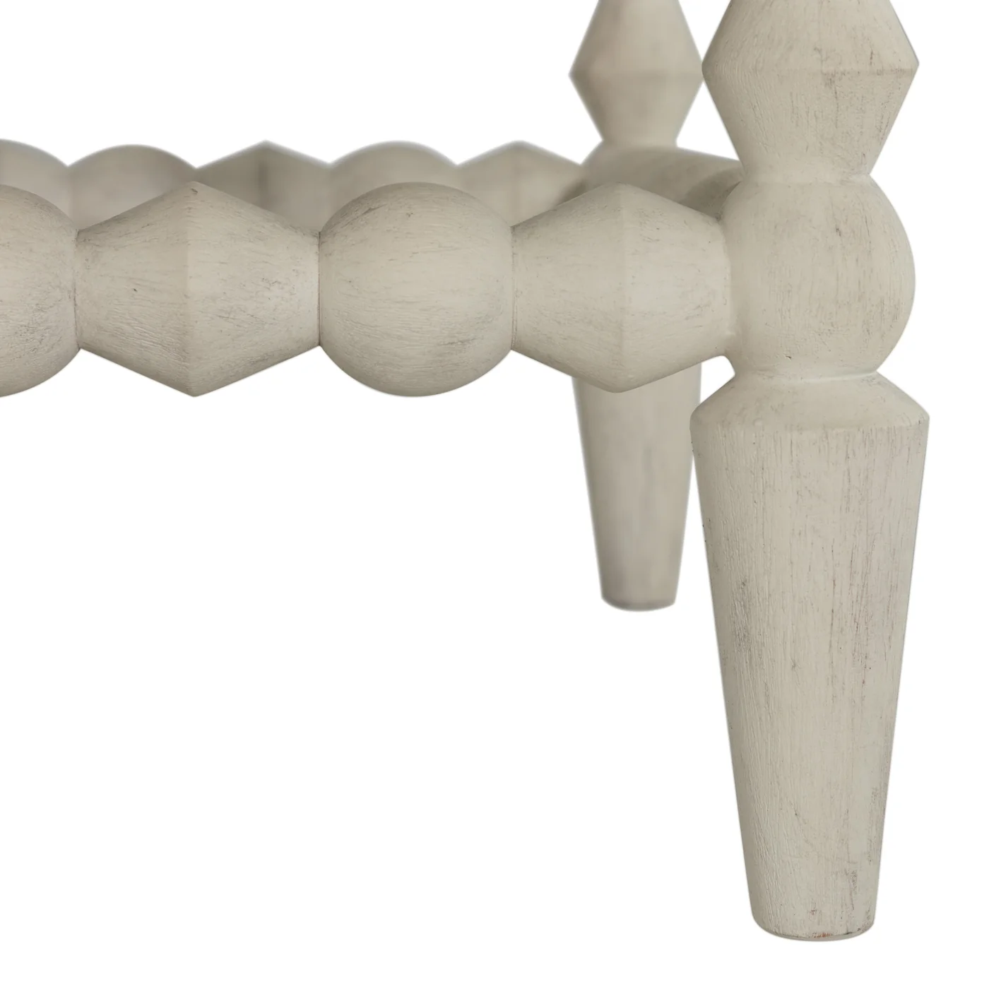 detail of antique white finish on bobbin style ottoman legs